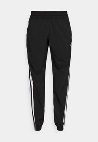 Czarne spodnie sportowe z elastycznym pasem, z białymi paskami po bokach i zwężanymi nogawkami. Wykonane z lekkiego materiału.