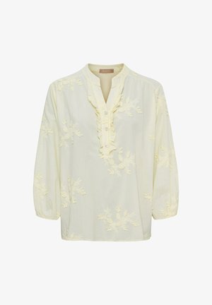 Cremefarvet bluse med lange ærmer, blomsterbroderi, flæset V-udskæring og tre knapper foran.