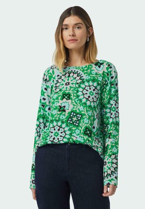 Green long-sleeve shirt featuring a floral pattern in shades of green, black, and white. Smooth fabric with a relaxed fit.