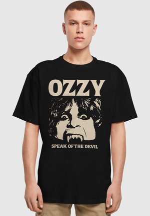 Black cotton t-shirt featuring a graphic design of a face with fangs and the text “OZZY” and “SPEAK OF THE DEVIL” in cream color.