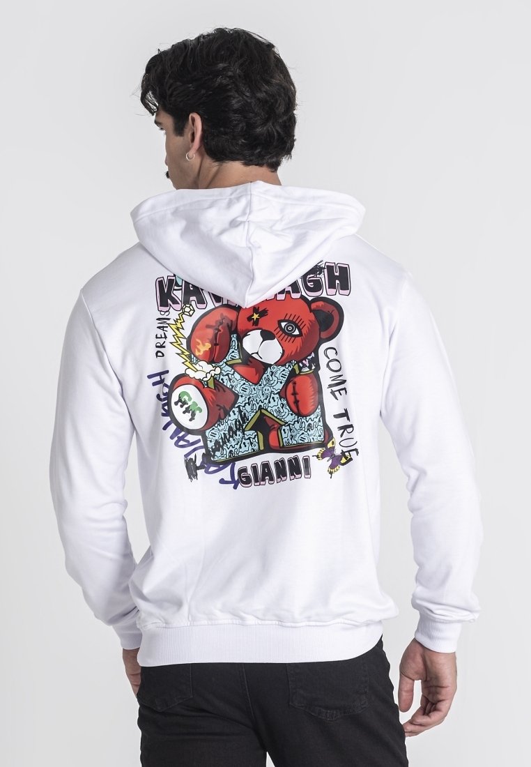 Sudadera blanca con un gráfico de oso de dibujos animados colorido en la parte posterior, con elementos de texto y contornos gruesos. Material de mezcla de algodón, corte relajado.
