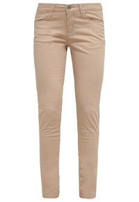 Beige skinny jeans tillverkade av mjuk bomull. Har framfickor, dragkedja och en knappstängning. Slät textur, skräddarsydd passform.