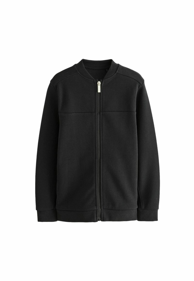 Veste noire zippée avec col, poignets et taille côtelés, présentée à plat sur un fond blanc.