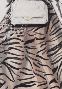 Beige fabric with black tiger stripes, featuring a quilted white handbag with gold hardware. Textured, high-contrast design.