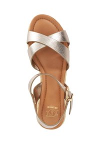 Open-toe sandal with metallic crisscross straps, cushioned tan footbed, and ankle buckle strap. Branding visible on footbed.