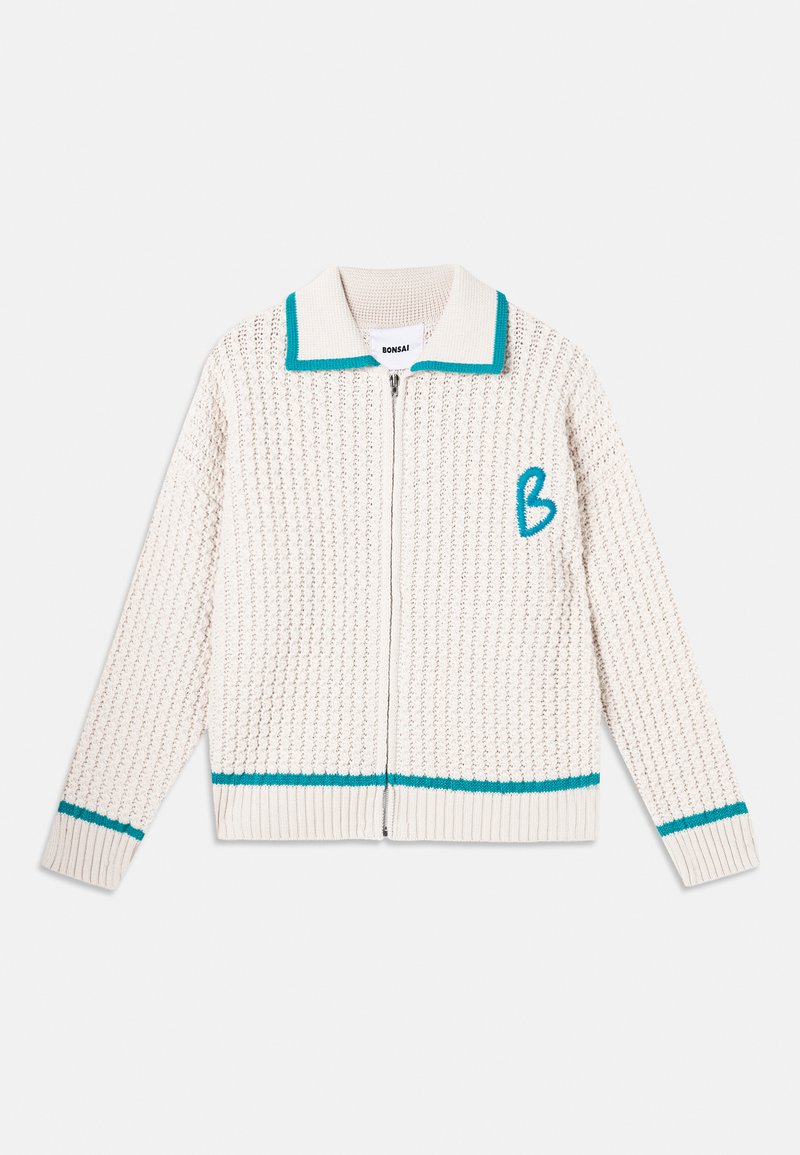 Knit cardigan in cream with a textured pattern. Features a zip front, turquoise collar and hem accents, and an embroidered letter "B."