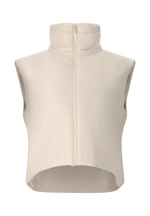 Hihaton beige-liivi, jossa korkea kaulus ja vetoketju edessä, hieman pidempi takaa, esitetty valkoisella taustalla.