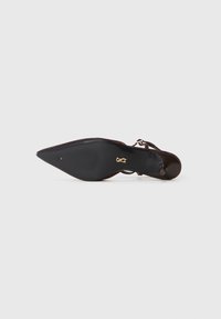 Black stiletto heel shoe with a pointed toe, featuring a smooth leather upper and a textured sole. Includes a thin ankle strap and gold hardware.
