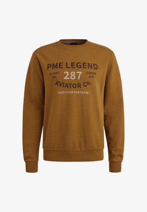 Musztardowy sweter z miękkiego materiału. Posiada okrągły dekolt, długie rękawy oraz nadrukowany tekst, w tym "PME LEGEND" i "FIND YOUR FREEDOM."