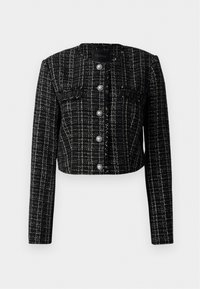 Musterapuline must cropped tweed jakk, millel on valge ruudumuster, pärlitest nööbid ja kaks esiflapikotid.