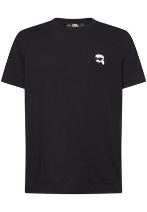 T-shirt nera in cotone con scollo rotondo e maniche corte. Presenta una piccola grafica bianca e grigia sul lato sinistro del petto.