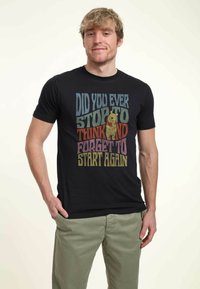 Black cotton t-shirt featuring colorful text: "Did you ever stop to think and forget to start again," with a graphic of a bear.