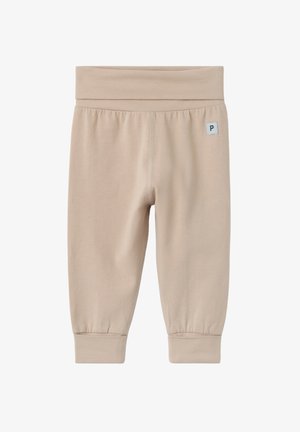 Pantalon bébé beige en tissu doux avec une large ceinture élastique et des poignets, petite étiquette logo carrée en haut à gauche.