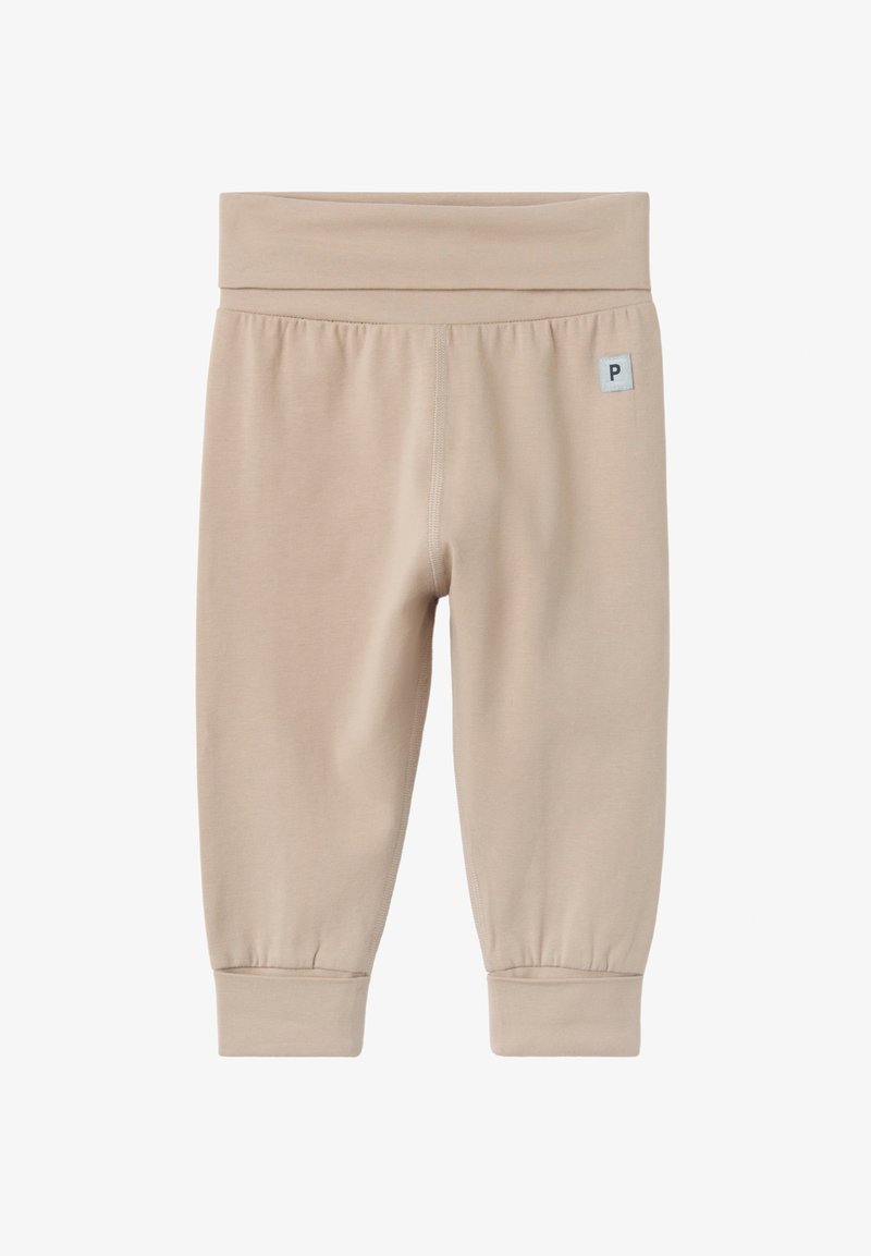 Pantalon bébé beige en tissu doux avec une large ceinture élastique et des poignets, petite étiquette logo carrée en haut à gauche.