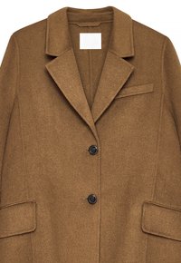 Brown wool blazer with notch lapel, two black buttons, and three pockets—two flap pockets at the sides and one chest welt pocket.