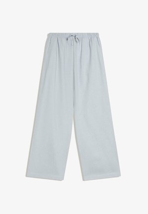 Svetlosivé široké nohavice s elastickým pásom a šnúrkou, vybavené bočnými vreckami a voľným, pohodlným strihom.