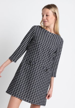 Navy and white checkered dress with a straight cut, three-quarter sleeves, two front pockets featuring black buttons, textured fabric.