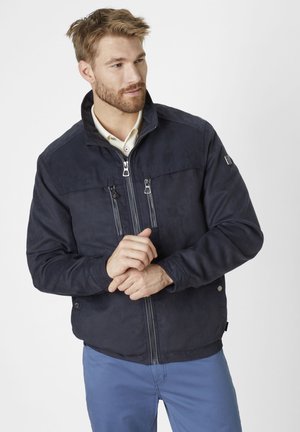 Navy blue jacket with a high collar, front zip closure, and two zippered chest pockets. Smooth fabric with slight sheen and fitted design.