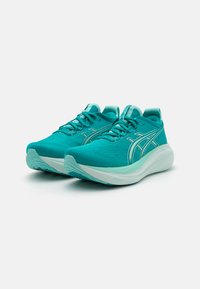 Turquoise athletic shoes made of breathable mesh, featuring a cushioned sole, lace-up design, and reflective accents on the side.