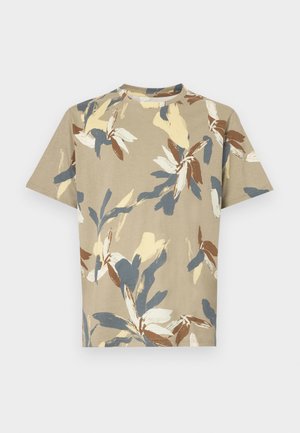 T-shirt de manga curta e decote redondo em bege, com estampa floral multicolorida em azul, amarelo e castanho. Tecido suave com um corte relaxado.