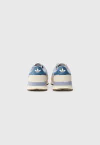 Blue and cream sneakers with a suede and mesh upper, featuring three white stripes, a padded collar, and a light rubber sole.