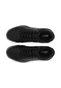 Zapatos deportivos negros con parte superior sintética, cierre de cordones, cuello acolchado y suela texturizada, que muestran un diseño elegante y un logotipo.