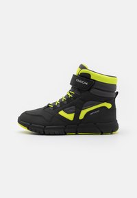 Schwarze High-Top-Sneaker mit neon-gelben Akzenten; synthetisches Material, Netzgewebe-Paneele, gepolsterter Kragen, Klettverschluss und strukturierte Gummisohle.