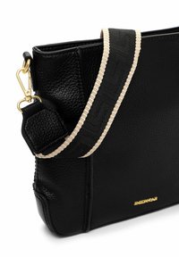 Czarna skórzana torba o fakturowanym wykończeniu. Posiada kremowy regulowany pasek w paski oraz złote akcenty metalowe. Kompaktowy, prostokątny kształt.