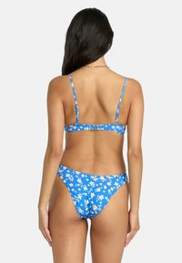 Blue floral bikini with adjustable straps. Features a clasp back and high-cut bottoms, displaying a vibrant flower pattern against a blue background.