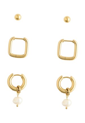 Three pairs of gold earrings: small round studs, large square hoops, and medium round hoops with irregular white pearl dangles.