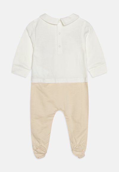 Body a maniche lunghe in cotone color crema e beige. Dotato di colletto, chiusura con bottoni sul retro e polsini elasticizzati alla caviglia.