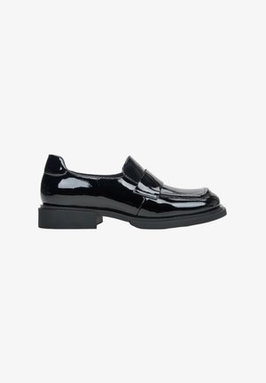Black patent leather loafers with a low block heel, featuring a smooth texture, rounded toe, and a decorative strap across the instep.