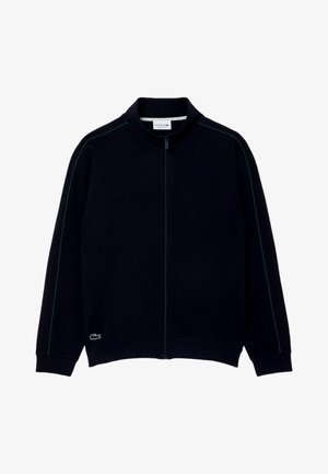 Schwarze Zip-Jacke mit hohem Kragen, versehen mit grünen Seitenstreifen und einem kleinen aufgestickten Logo unten links. Klassische Passform und lässiges Design.