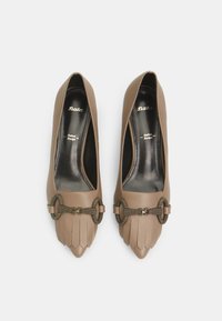 Décolleté in pelle marrone con punta affusolata, caratterizzati da un design decorativo a pieghe e una fascia in metallo a metà piede.