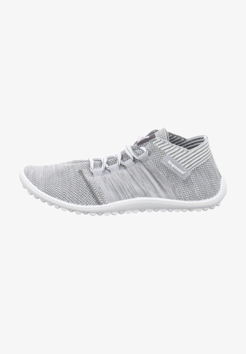 Gray knitted athletic shoe with a low top design, white sole, and textured accents. Features elastic laces and breathable mesh material.