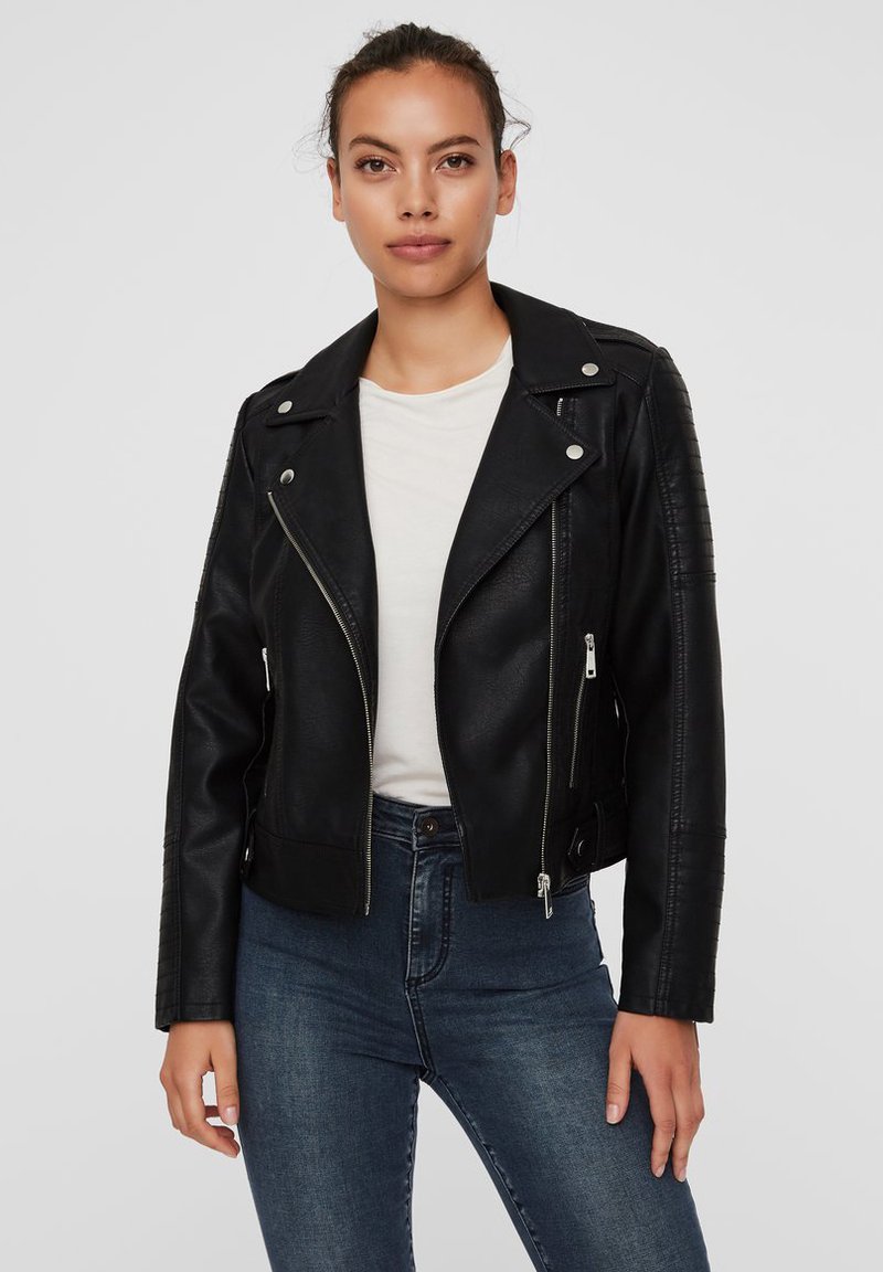 Black leather biker jacket with zippered front, silver hardware, quilted shoulder accents, and a fitted design. Worn over a white top.