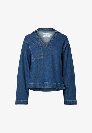 Denim bluze ar V-veida kaklu, garām piedurknēm un krūtīm kabatu. Audums ir vidēji zils ar nedaudz teksturētu apdari.