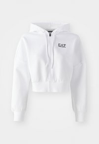 Bela skrajšana kapuca, spredaj z zadrgo, kapuca z vrvico, dolgi rokavi z rebrastimi zapestji. Na prsih je črn logotip "EA7". Gladka tekstura tkanine.