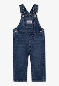 Salopette en denim bleu foncé avec des bretelles réglables, une poche avant et des boutons sur le côté. Présente un design classique à jambes droites.
