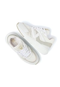 White athletic shoes featuring a mix of mesh and smooth material, rounded toe, padded collar, and contrasting beige accents on the sides.
