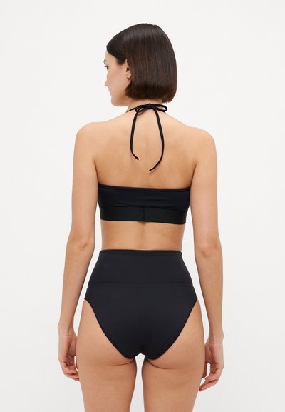 Black two-piece bathing suit featuring a halter-style top with a back tie and high-waisted bottoms. Smooth fabric with minimal seams.