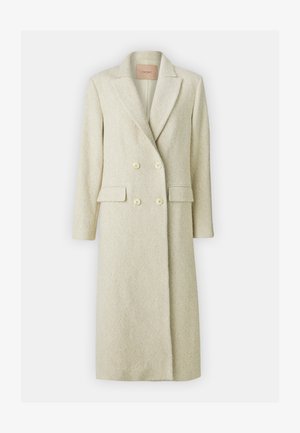 Casaco double-breasted em bege claro, feito de um tecido com padrão herringbone, apresentando lapelas em bico, dois bolsos frontais e botões redondos de cor creme.