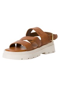 Brown leather sandal with three wide straps, open toe, and a white chunky sole featuring textured detailing. Buckle closure at the ankle.