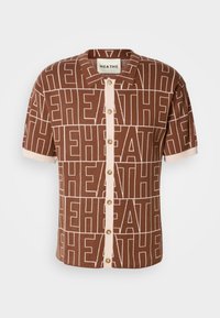 Short-sleeve, brown shirt with a repeating "HEATHE" pattern. Front button closure with beige accents and a collar. Soft, textured fabric.