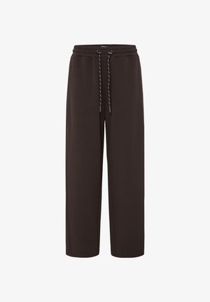 Loszittende donkerbruine joggingbroek met elastische tailleband en zwart-wit trekkoord, weergegeven op een witte achtergrond.
