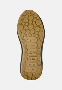 Black shoe sole with a textured, circular pattern in a light brown color. Features the word "CAMPER" prominently and size "38" embossed.