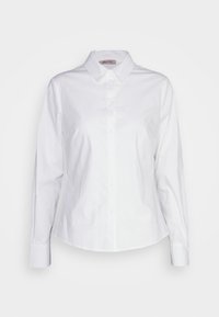 Chemise blanche boutonnée en coton avec col pointu, manches longues et ourlet légèrement arrondi. Design minimaliste, sans motifs.