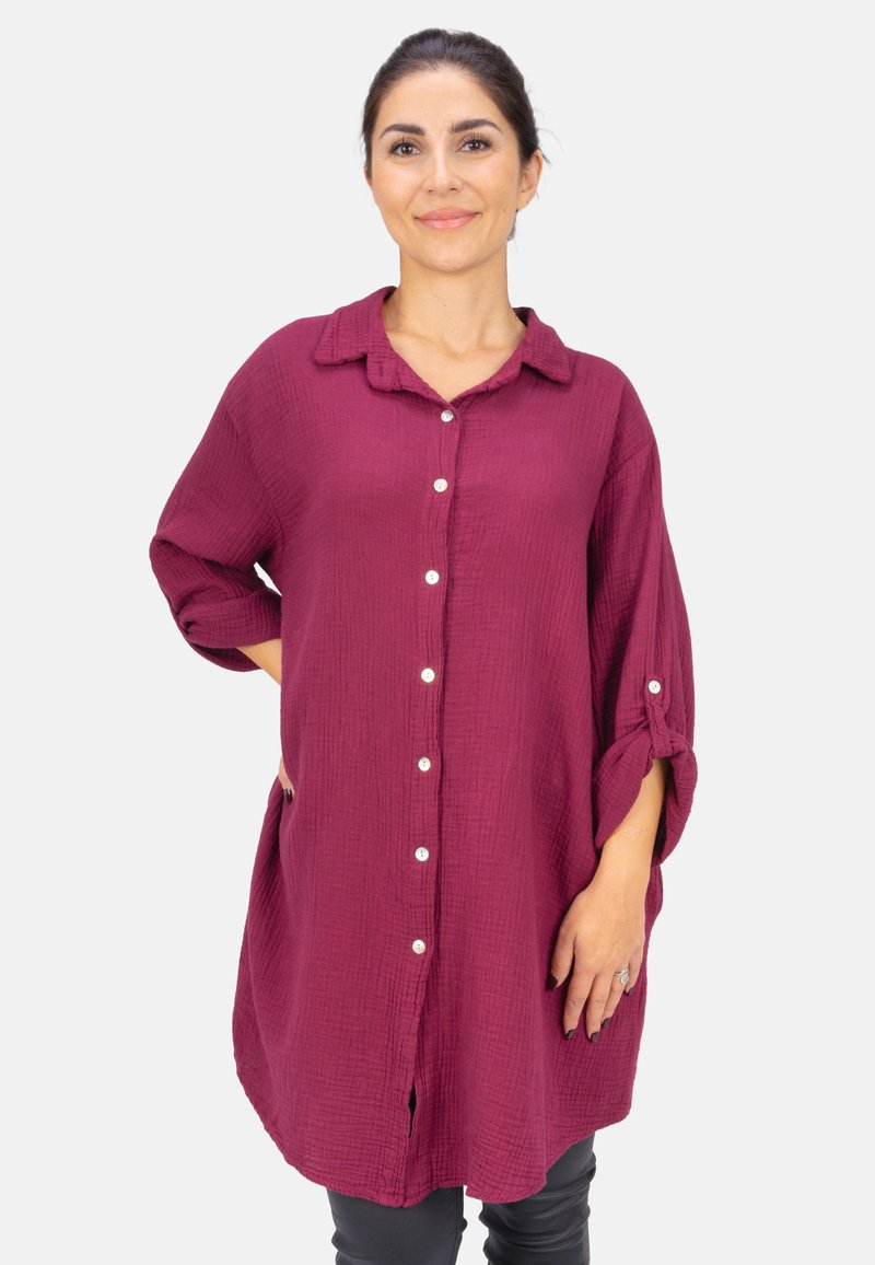 Burgundy button-up shirt with short roll-up sleeves, textured fabric, collared neckline, and side pockets.