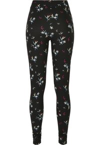 Leggings noirs avec un motif floral comprenant des fleurs blanches, bleues et roses. Fabriqués en matériau extensible avec un design ajusté.