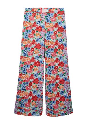 Pantalon à jambes larges avec un motif floral vibrant en rouge, rose, orange et bleu sur un fond clair, avec une étiquette "LA PLAGE" sur la ceinture.